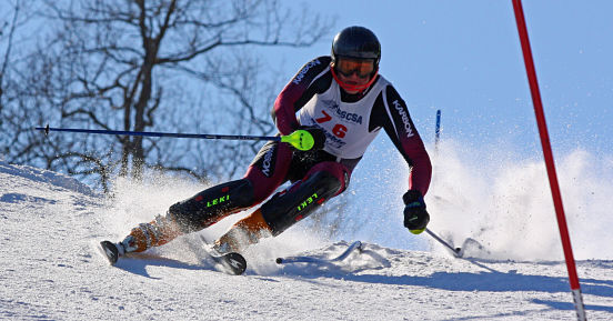 A member of the Ski Club races downhill.