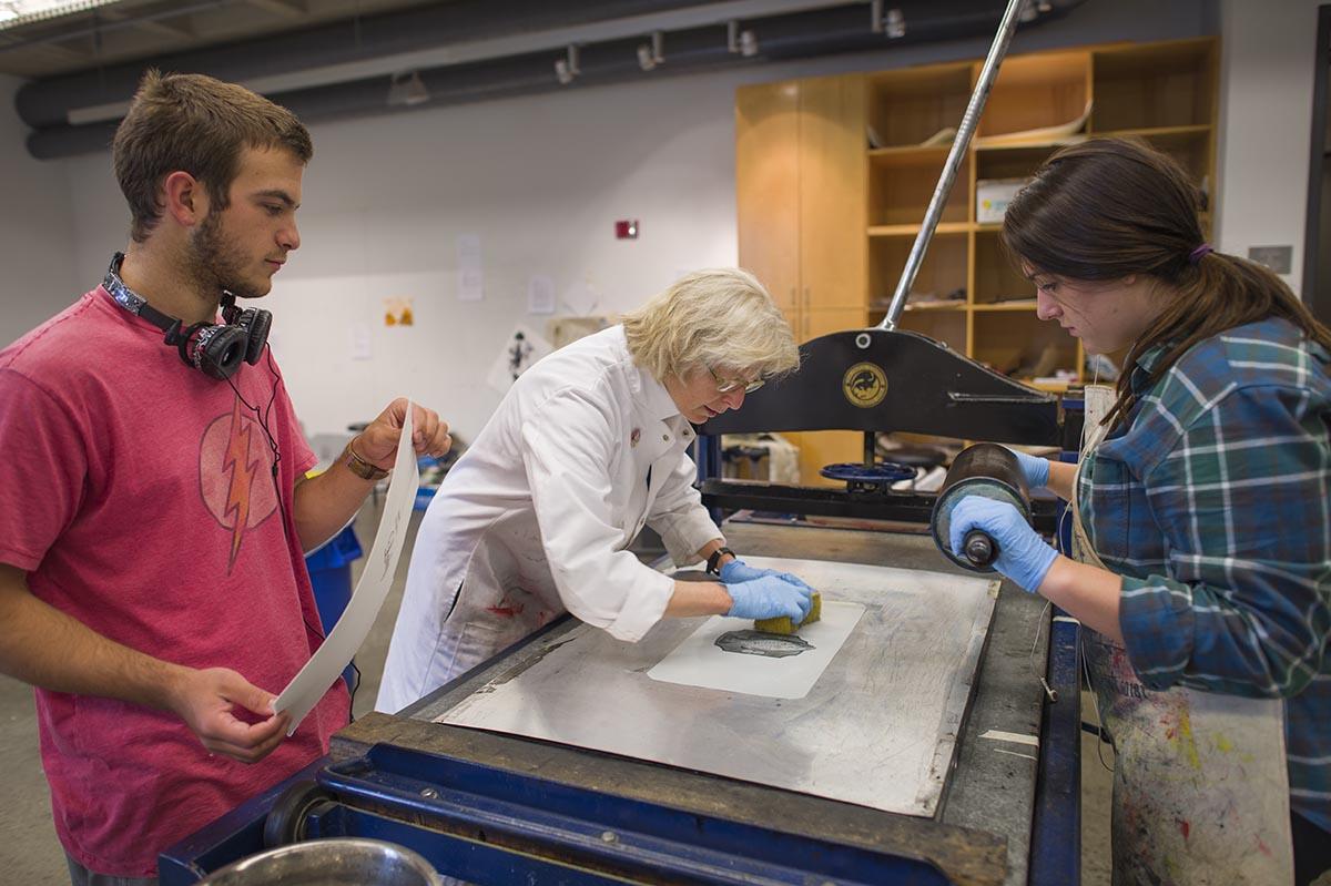 Students work with Professor Lynn Schwarzer in Little Hall’s printmaking studio.