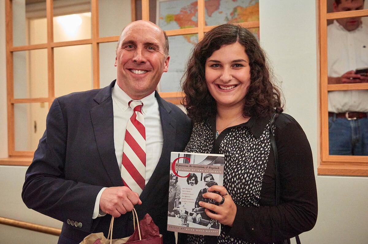 Emily Kahn ’19, one of the authors of a book on the history of Jewish life at Colgate, shares the book with President Brian W. Casey.