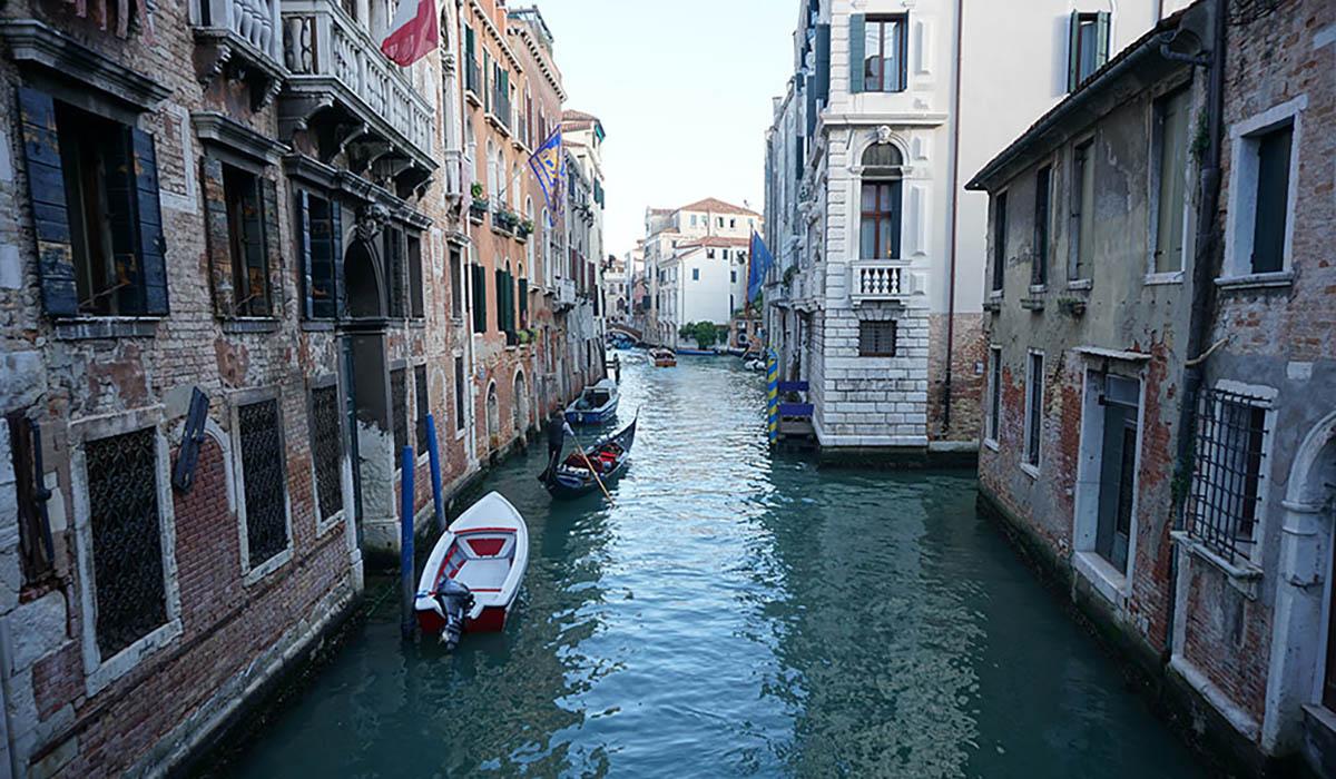 A canal running between buildings in Venice, Italy.