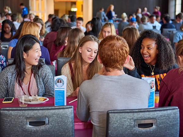 Students laugh and chat over brunch