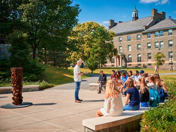 Peter Klepeis teaches an FSEM course on "The Geography of Happiness" to first-year students on a sunny afternoon outside the Ho Science Center.