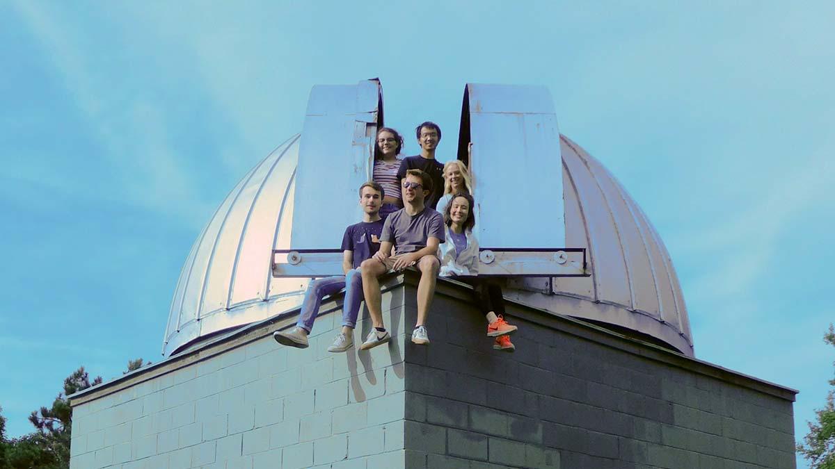 Summer astronomy researchers atop the roof of the observatory