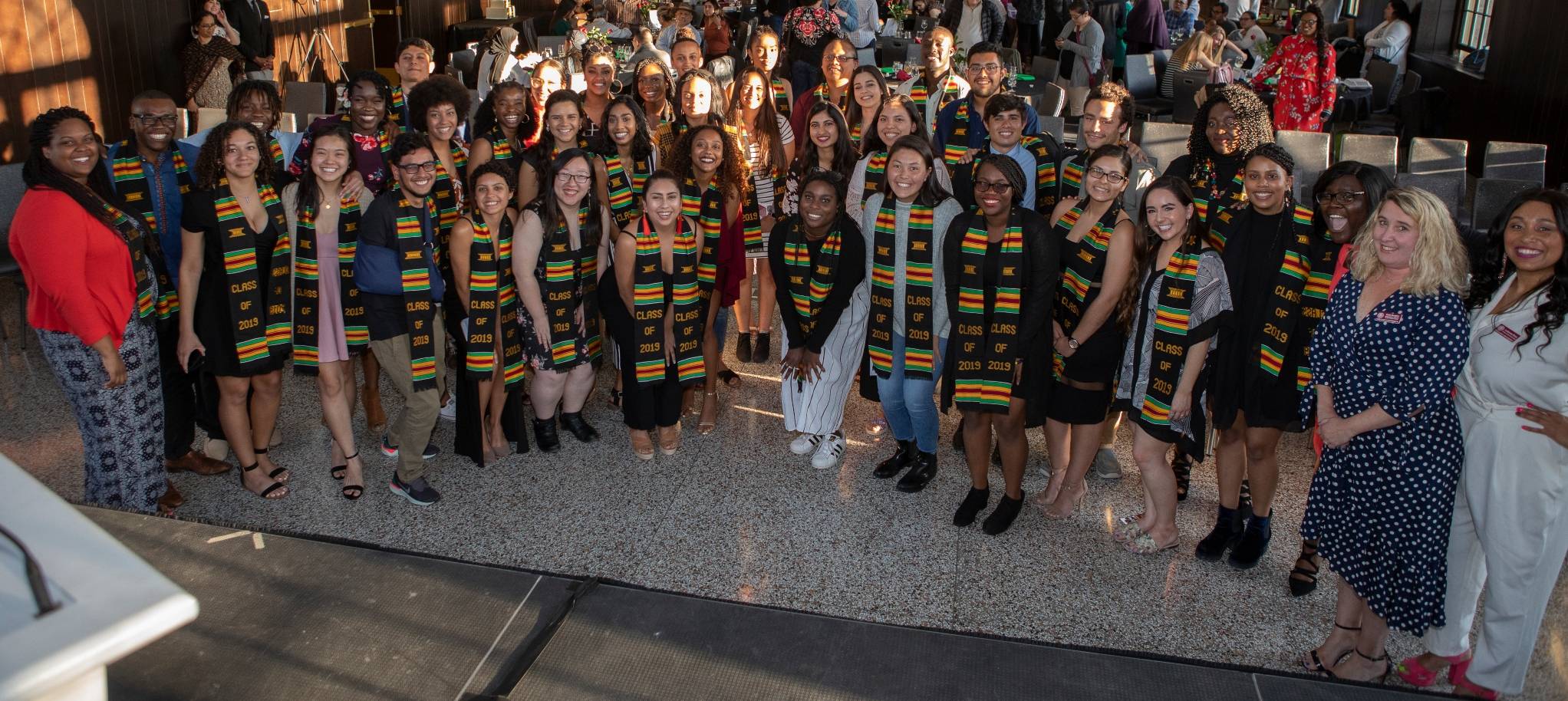 2019 senior class gathers with kente cloth stoles adorned