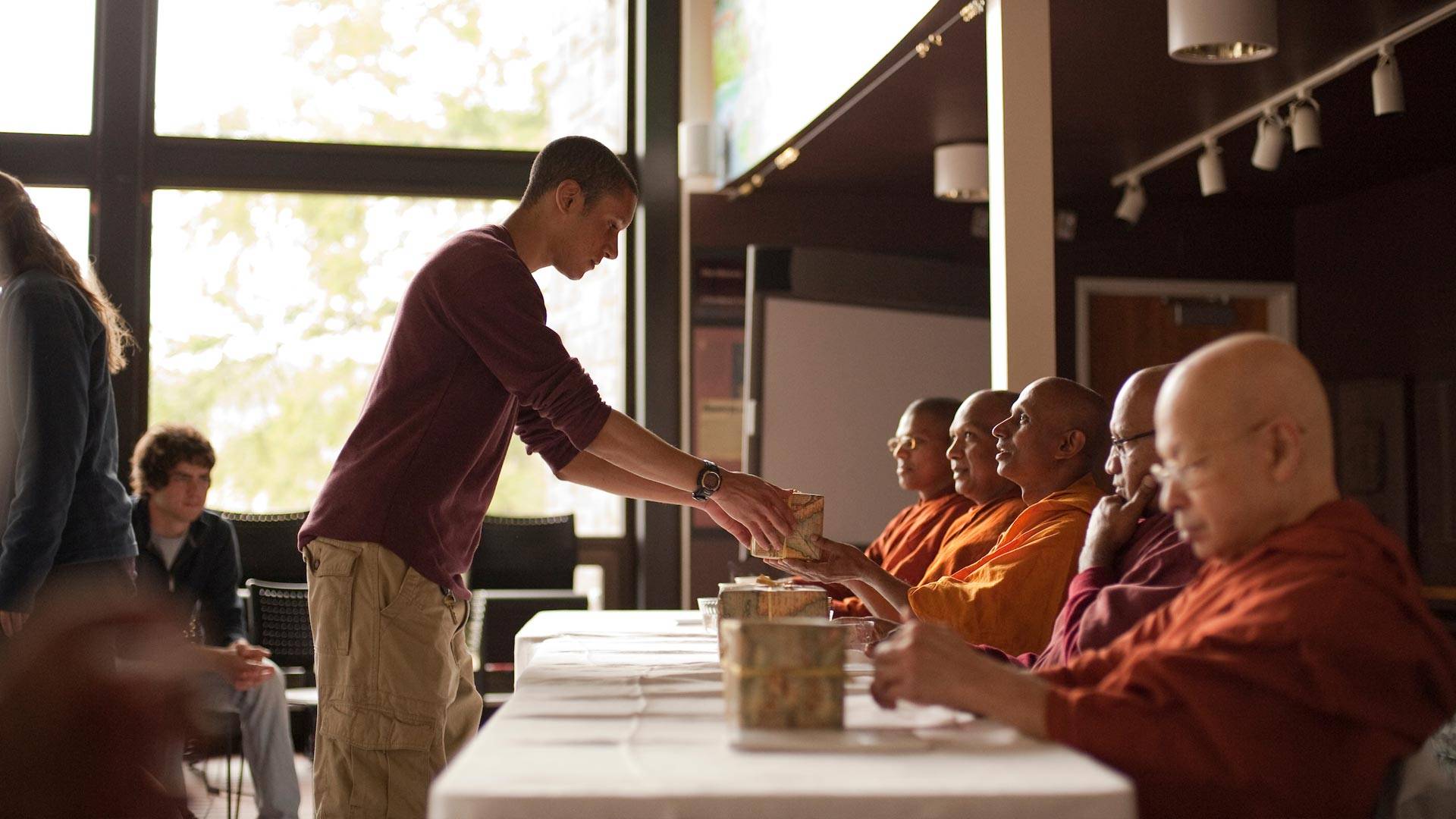 Members of the Colgate community took part in a Dana, an act of giving or making an offering to the Sangha, the monastic order of ordained Buddhist monks or nuns.