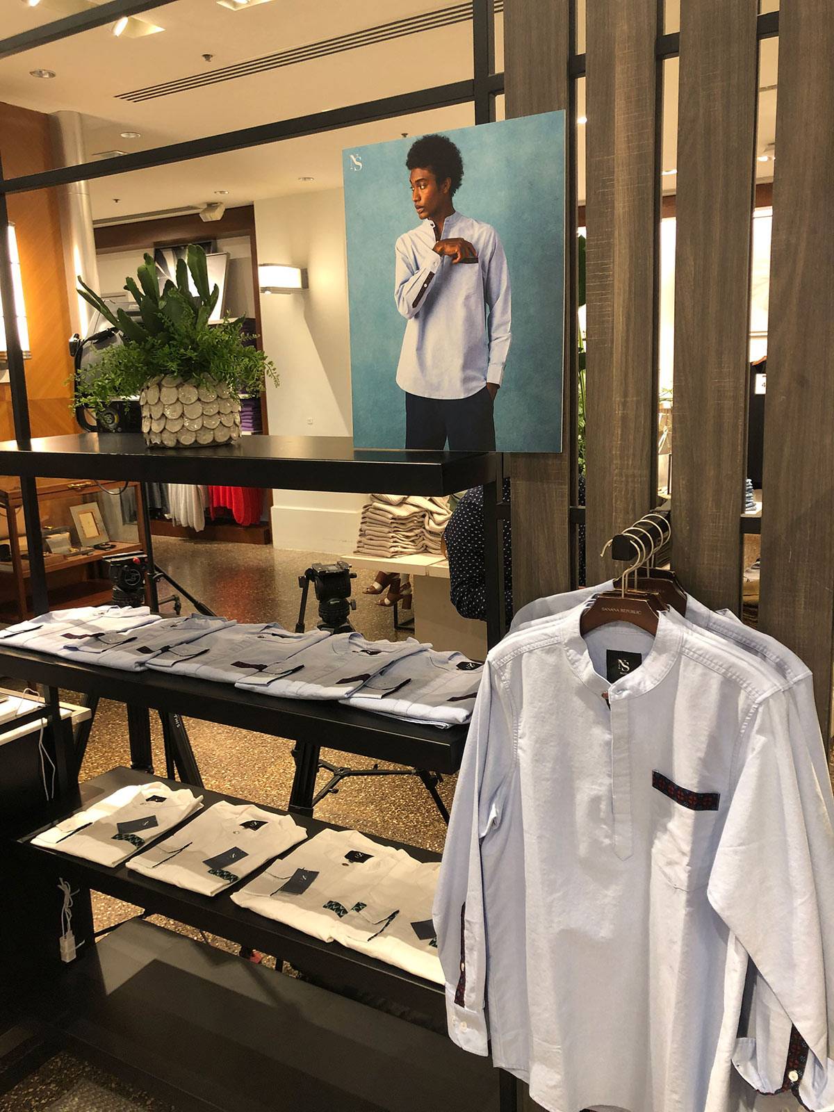 White shirts hanging up at a clothing store