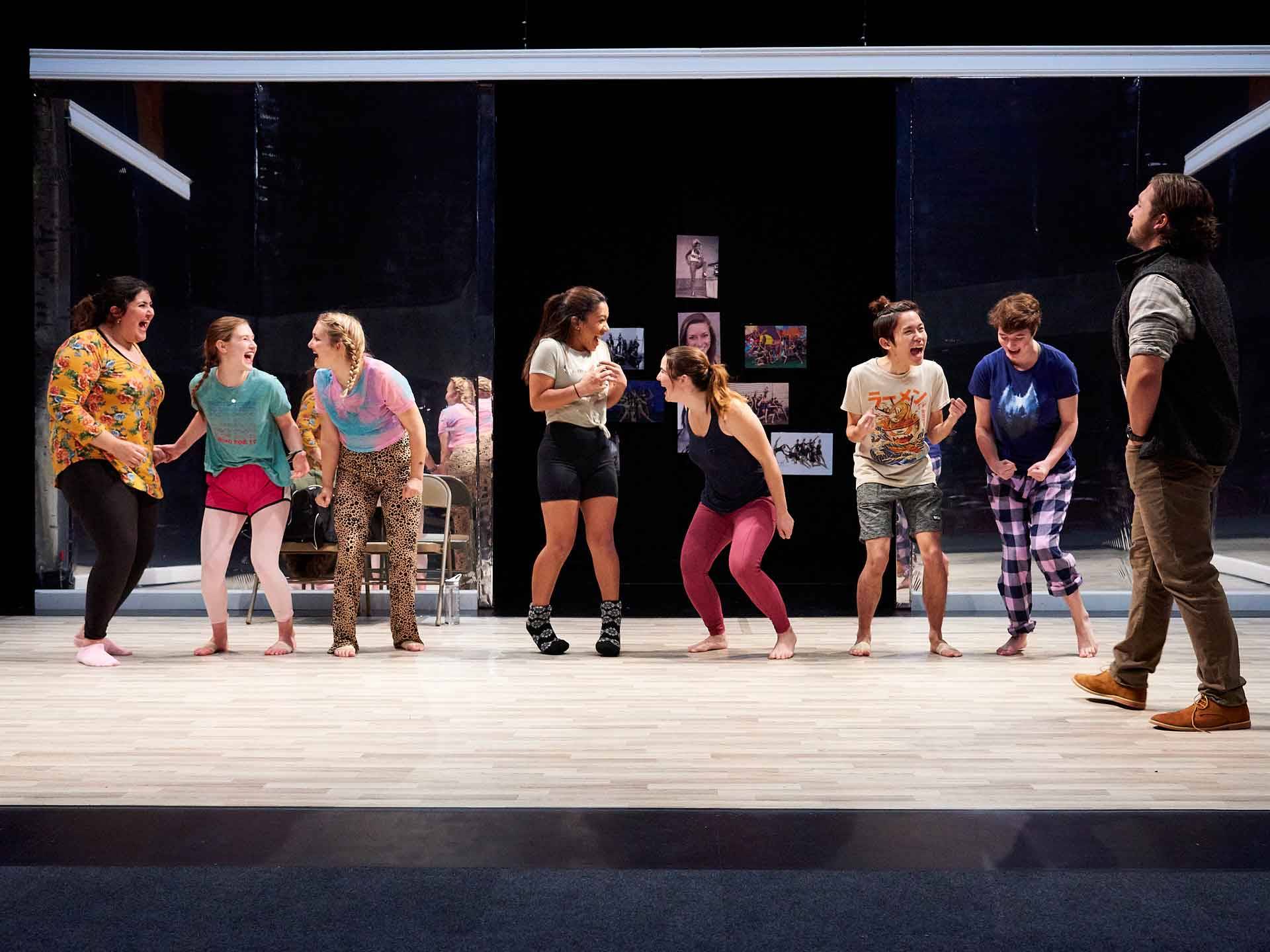 Eight student actors in a straight line on the set of Dance Nation