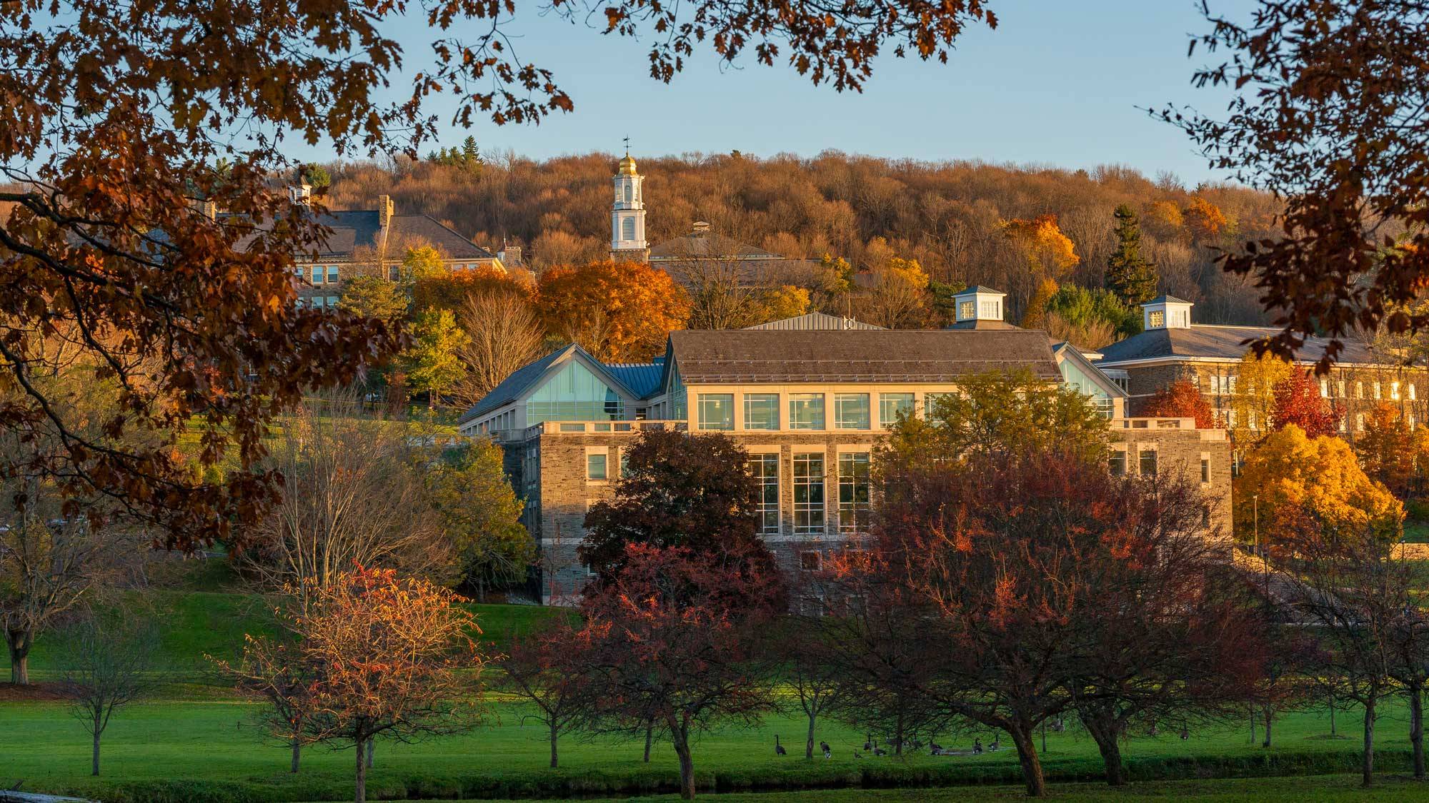 campus buildings with autumn backdrop