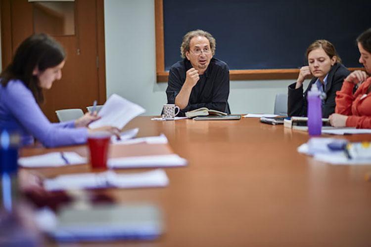 Peter Balakian is seated a table teaching an English class in Lathrop Hall