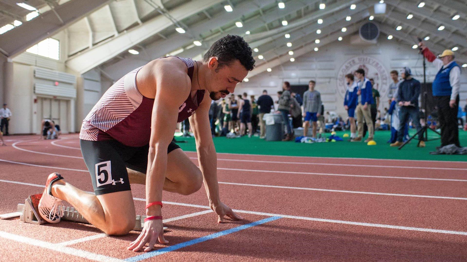 Oliver Moe at the starting block for a race in Colgate's Sanford Field House