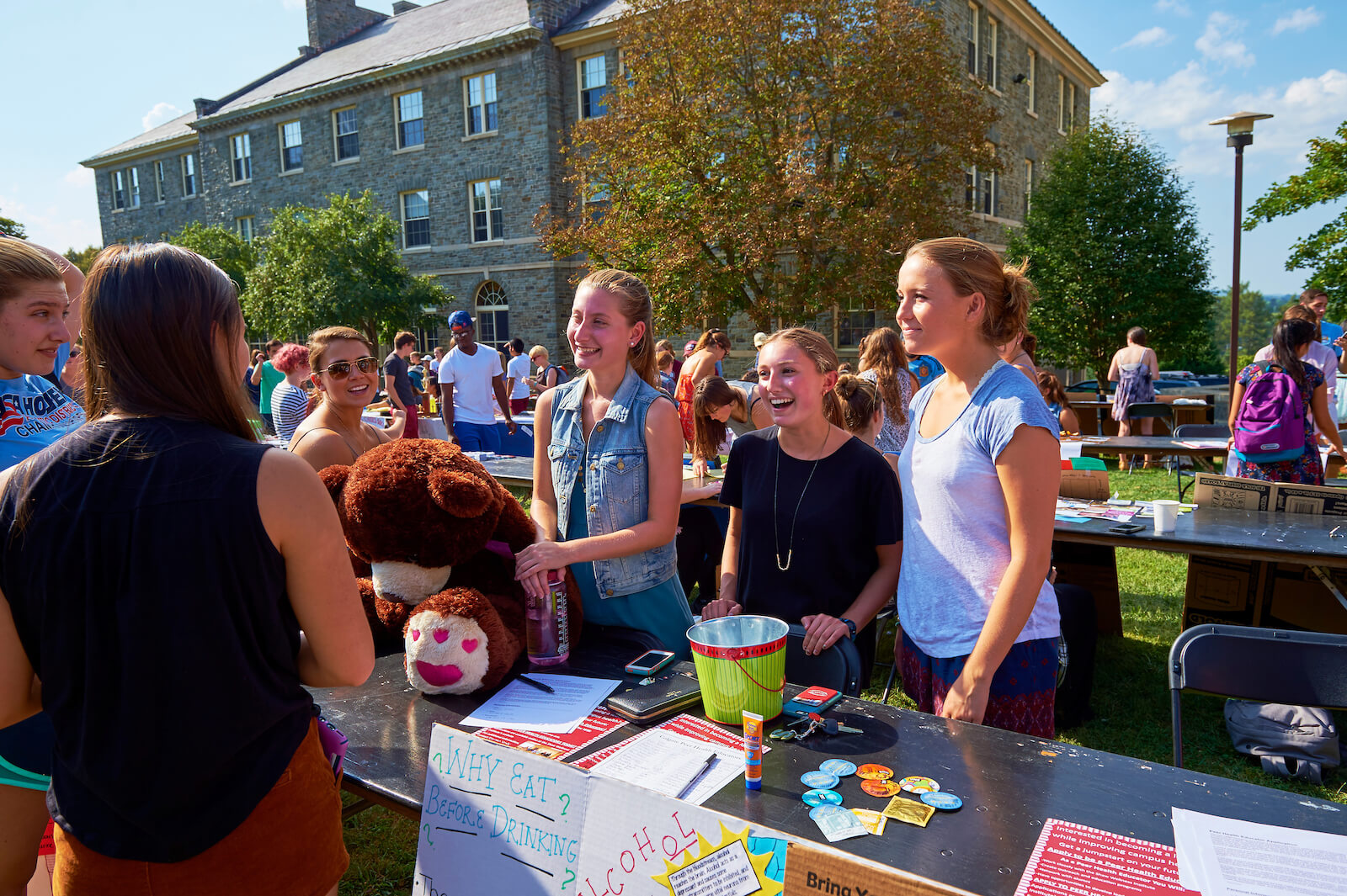 Three leaders of a Colgate club recruit members at the student involvement fair