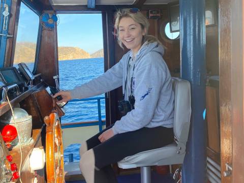 Lauren Horstmyer at helm of boat