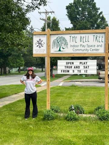 Corey McLaughlin ’24 next to Bell Tree sign