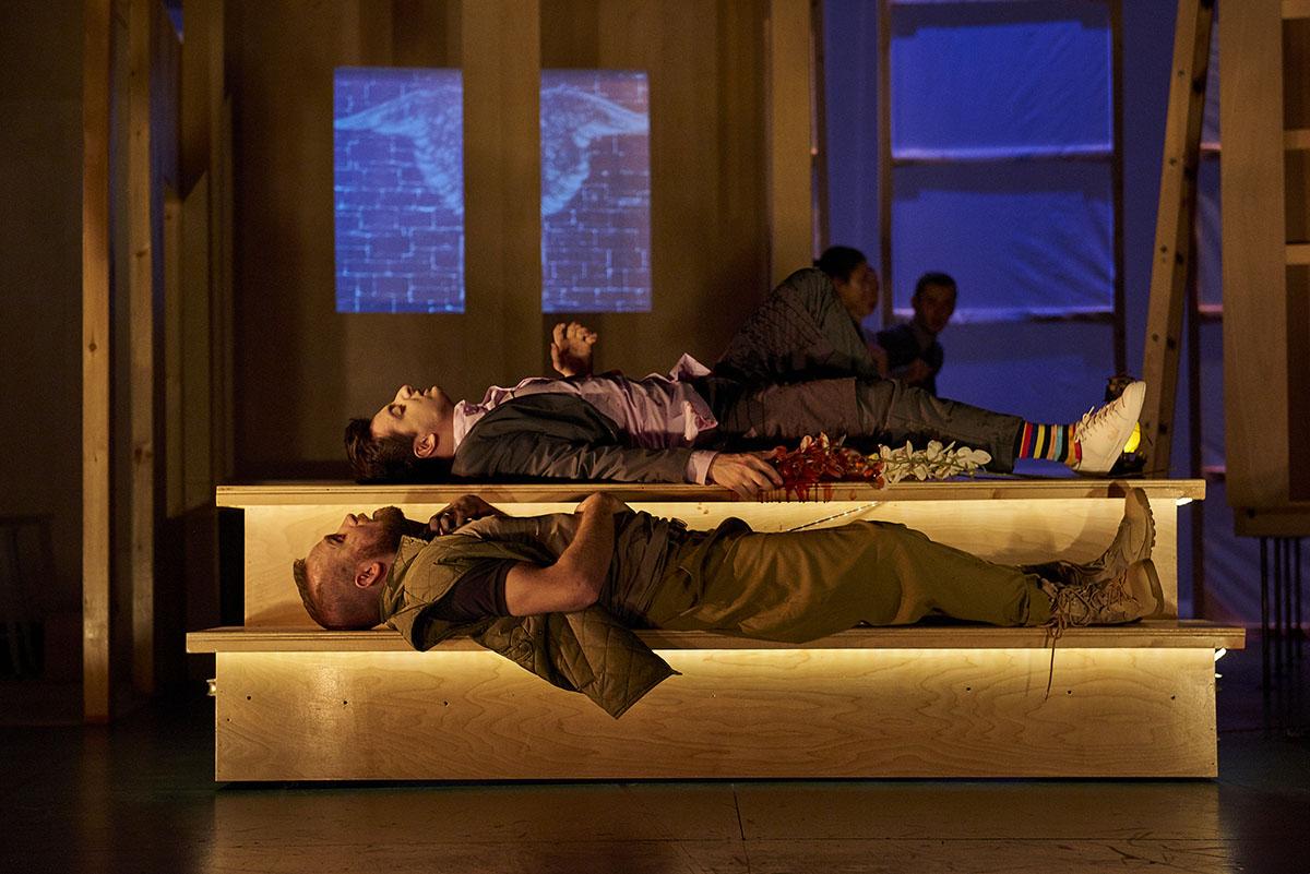 Two student performers lay down on stage during a main stage production of Romeo and Juliet and Zombies.