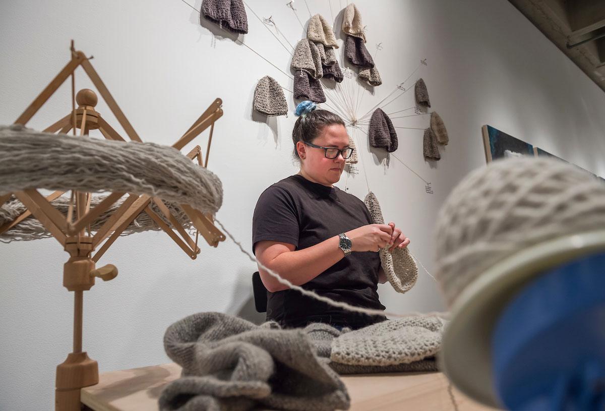 Kris Pfister ’17 works on her art installation titled Casting Off in the Clifford Gallery.