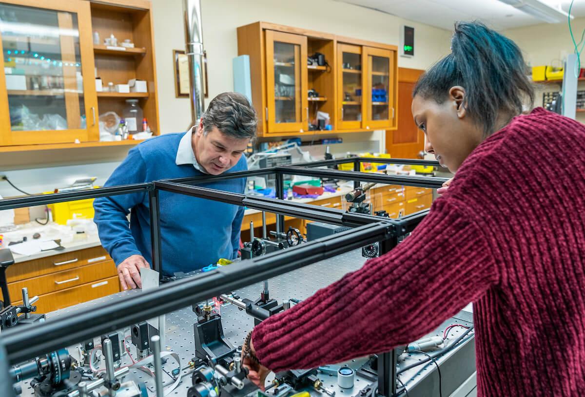 Charles A. Dana Professor of Physics and Astronomy Enrique Galvez works with a student in the Ho Science Center laser lab. 