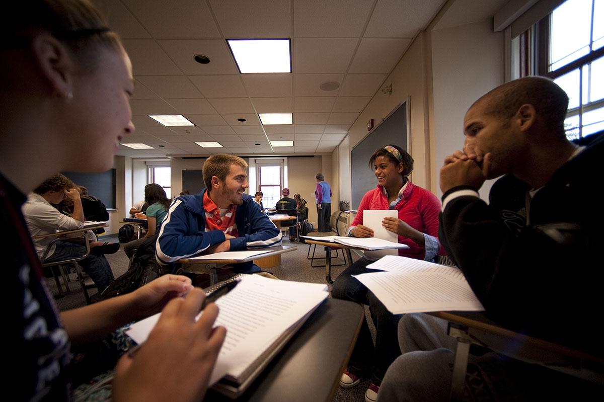 Students share comments on each other’s work in a group exercise during a writing and rhetoric class.