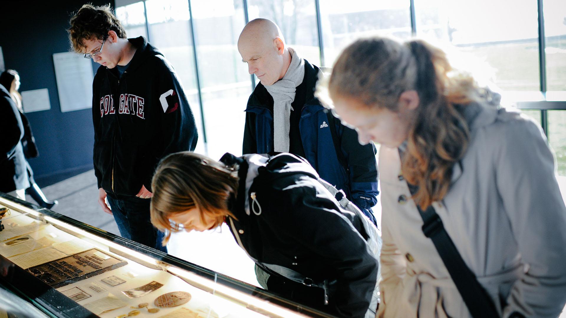Professor Andy Rotter and students examine a museum case in Belgium