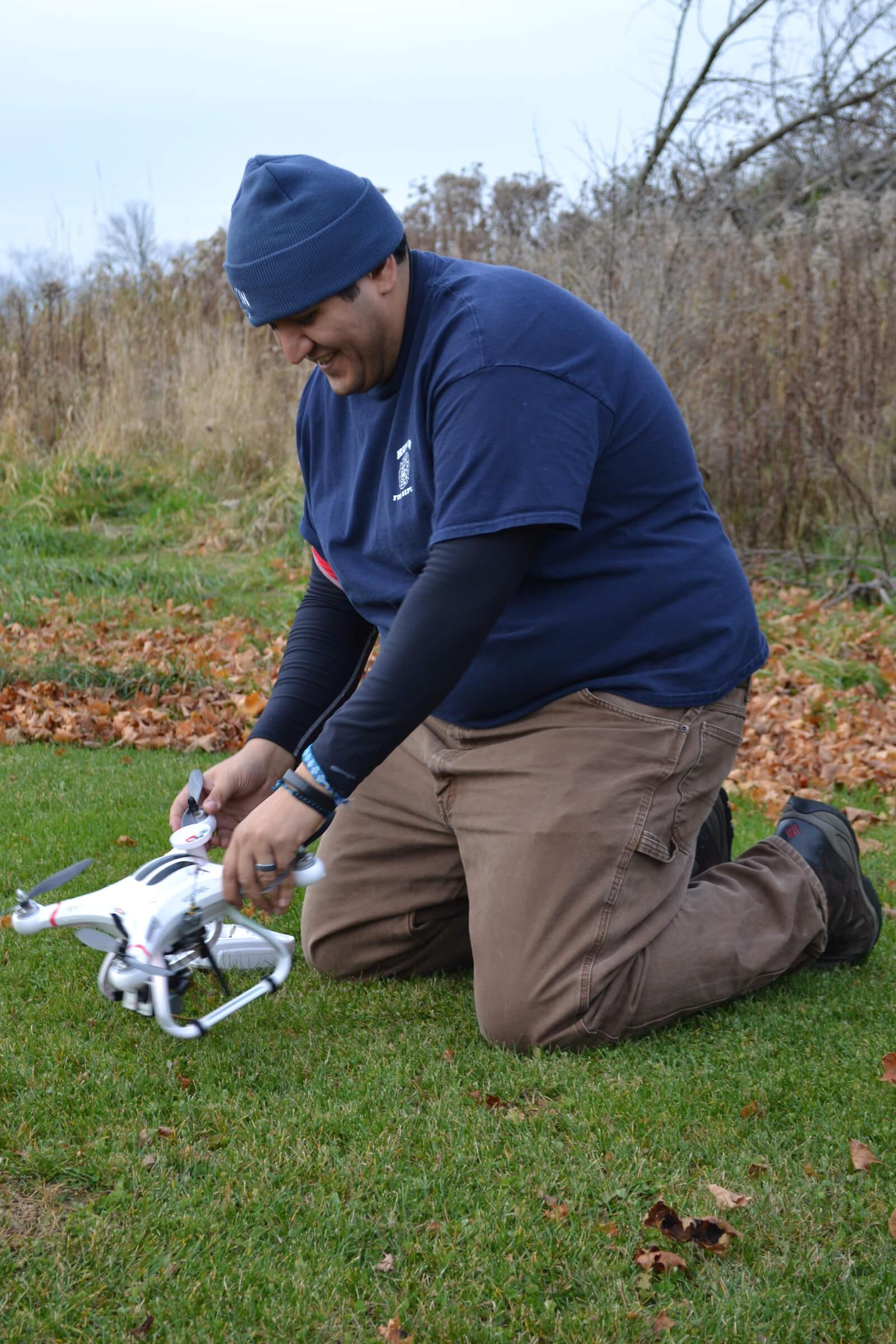 A Colgate student prepares a drone for flight as part of a simulated battle exercise.