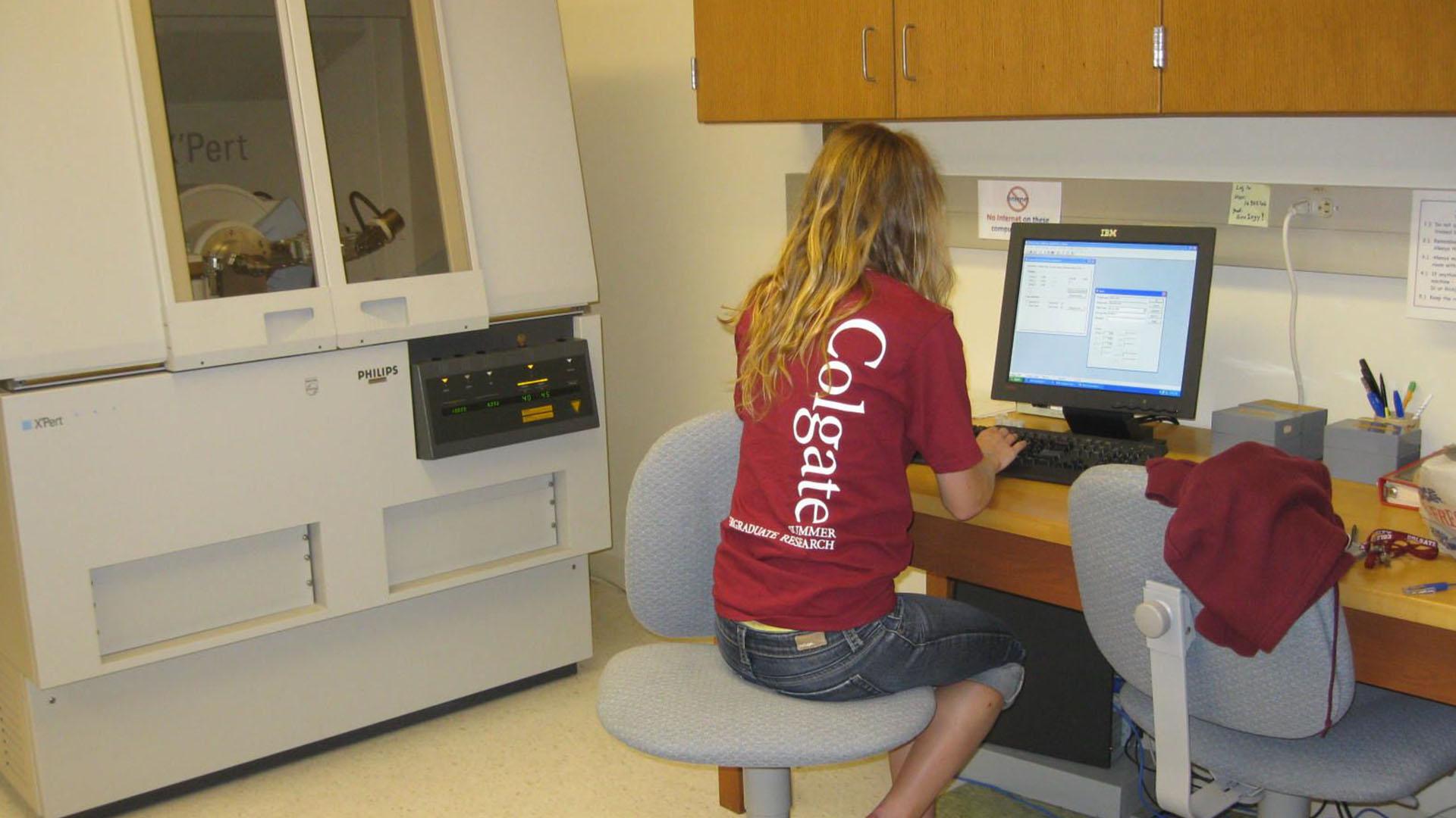 Student using x-ray diffractometer in lab