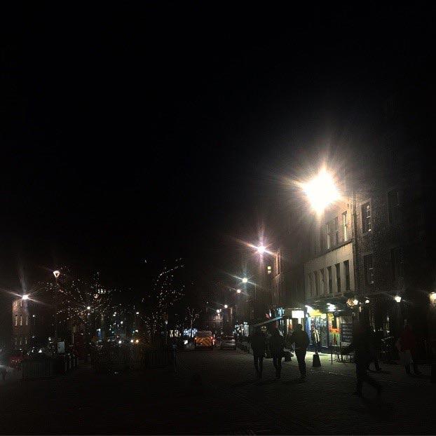 Streetlights illuminate an Edinburgh street at night