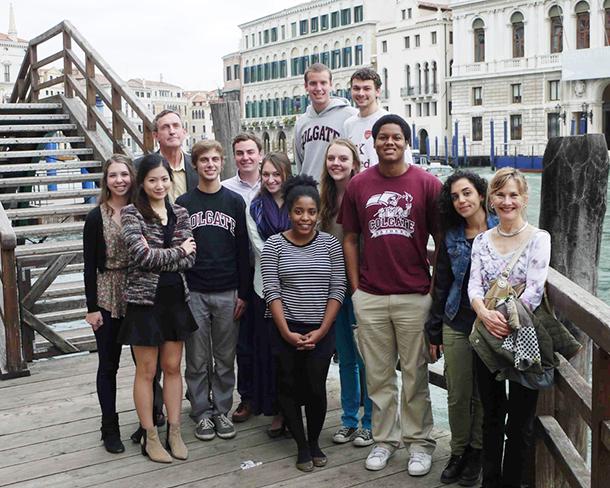 Group of students stops for a photo along a canal in Venice.