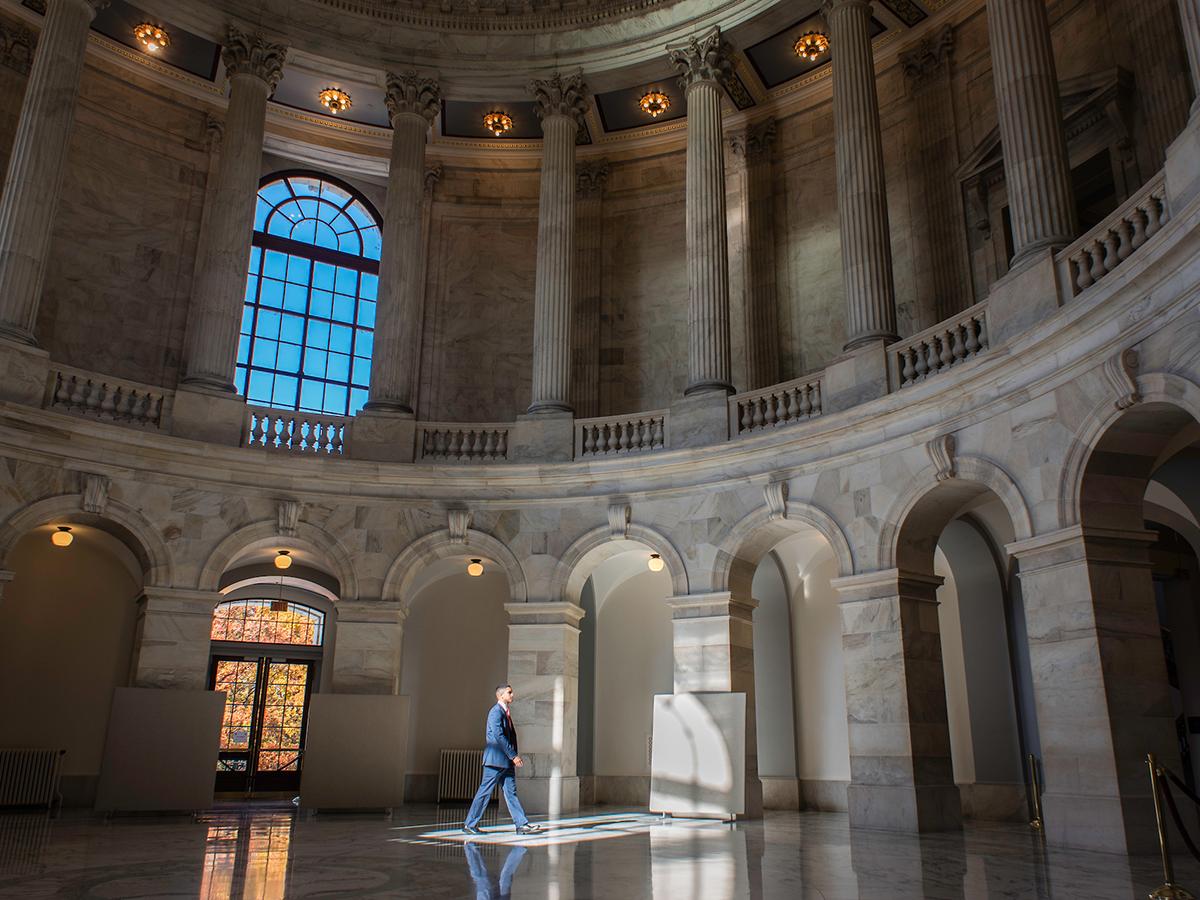 Franco Brunet strides across the Rotunda in the Russell Building.