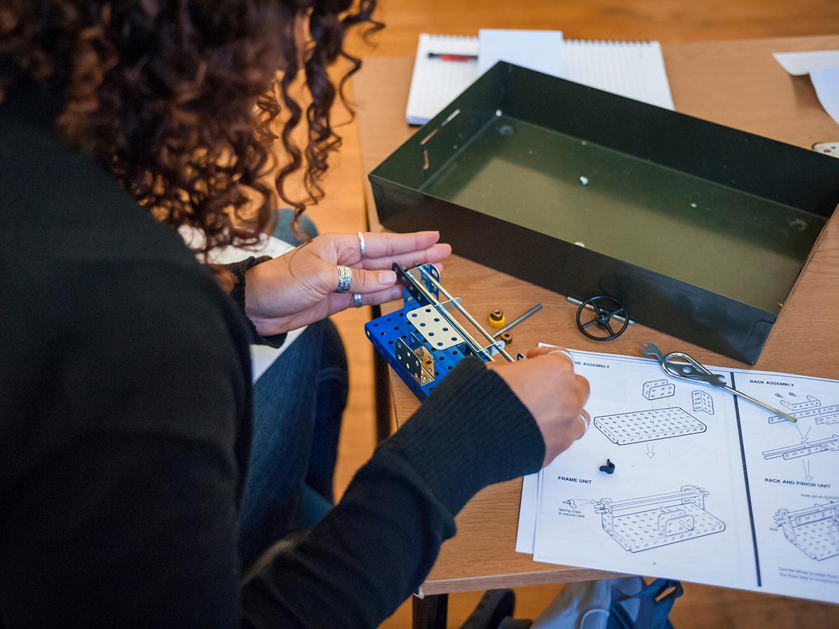 A Colgate students constructs an engineering model.