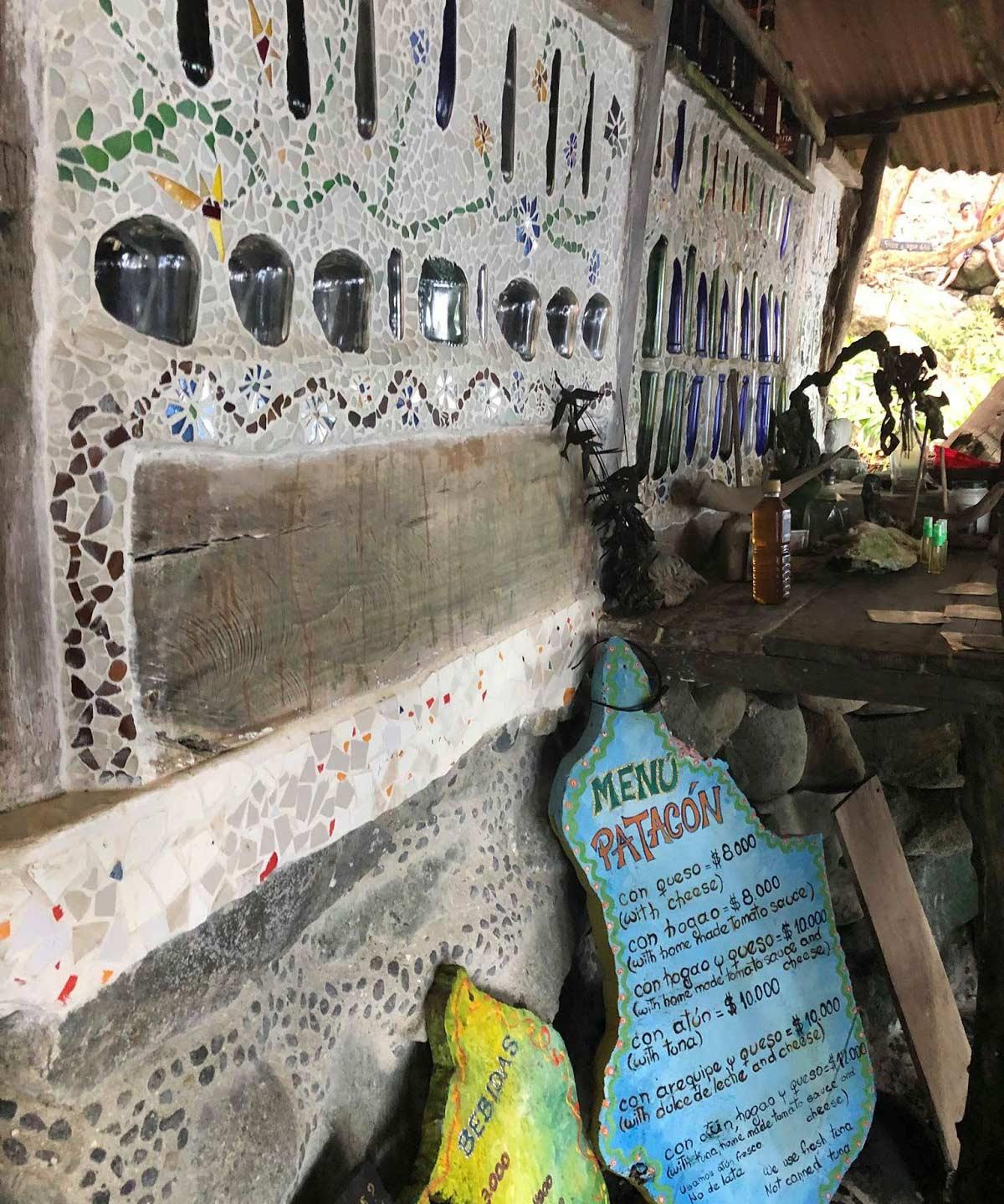 A structure with old glass bottles built into the wall for decoration