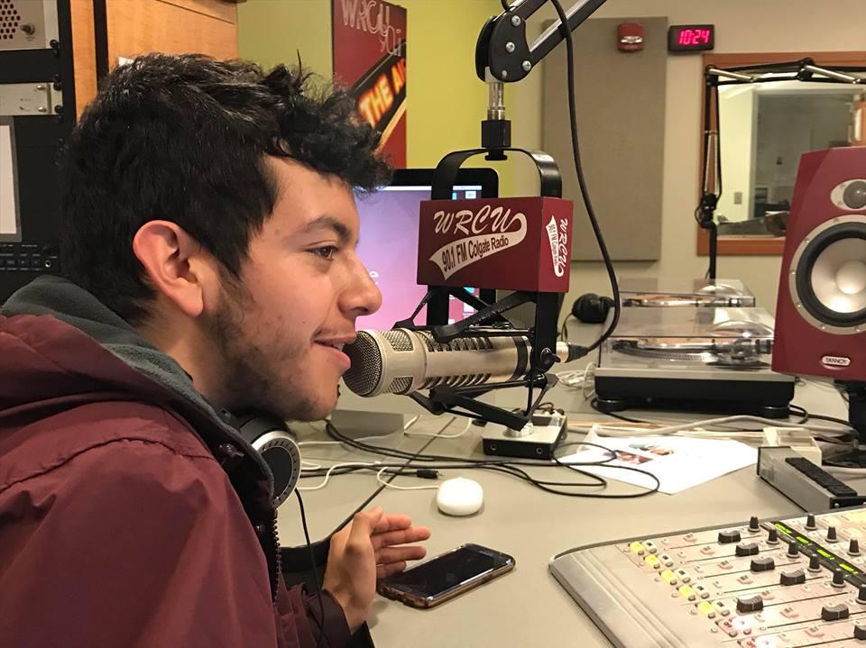 Ryan Rios at the microphone in the WRCU student radio station