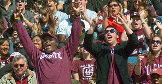 Alumni students, parents, and families cheer on Raider Football.