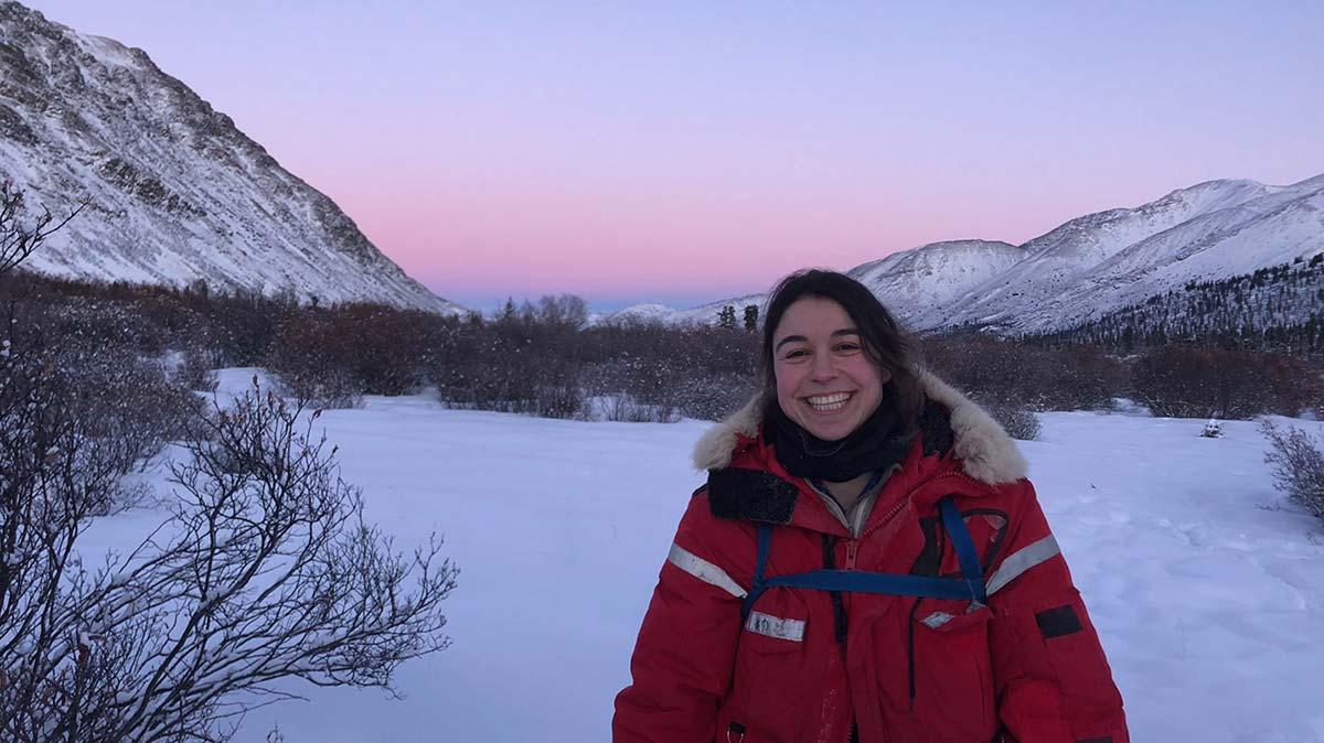 Student in a parka studying impact of climate change in the Canadian wilderness