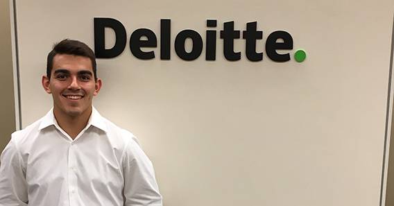 Lucas Cooper ’18 in front of the Deloitte Corporate Finance sign