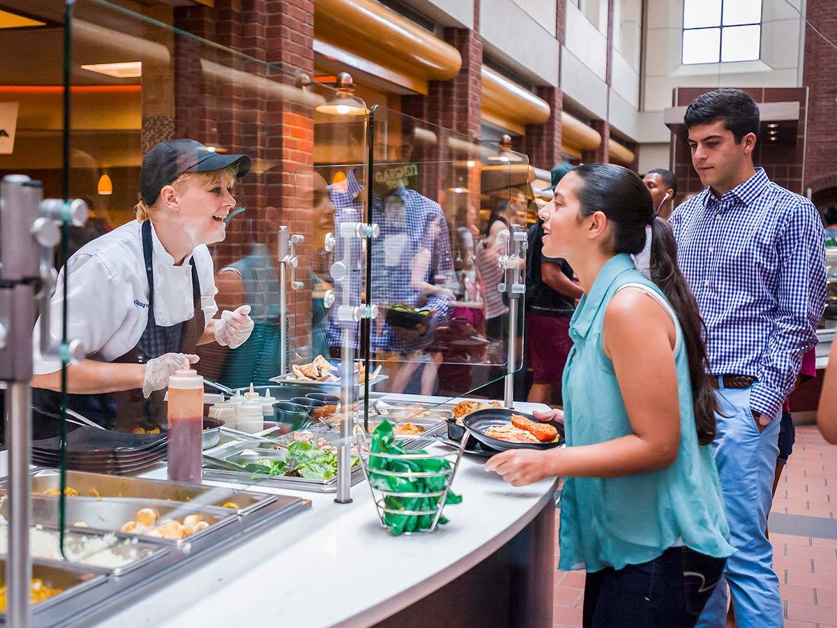 Student being served food at a station in Frank Dining Hall