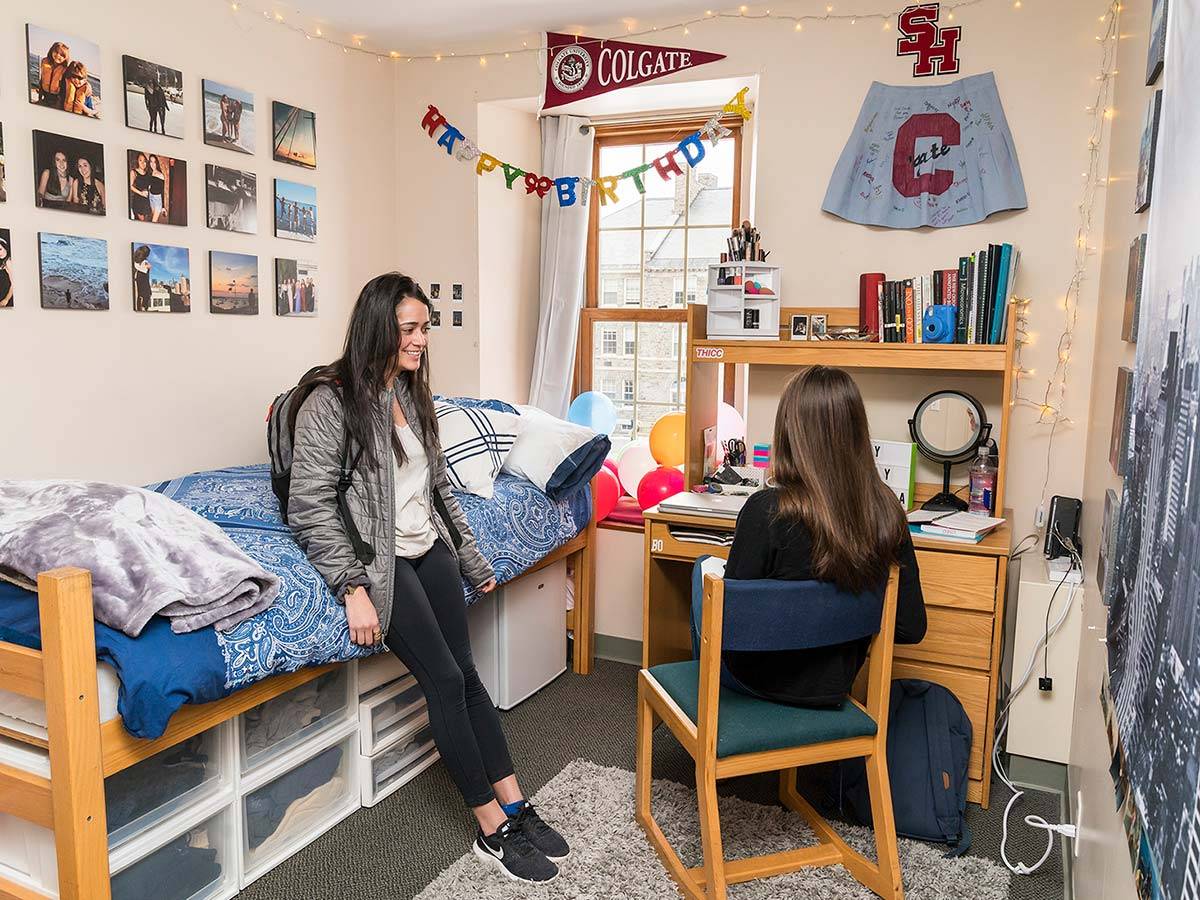 Two students chat in a student bedroom in one of Colgate's Residential Commons