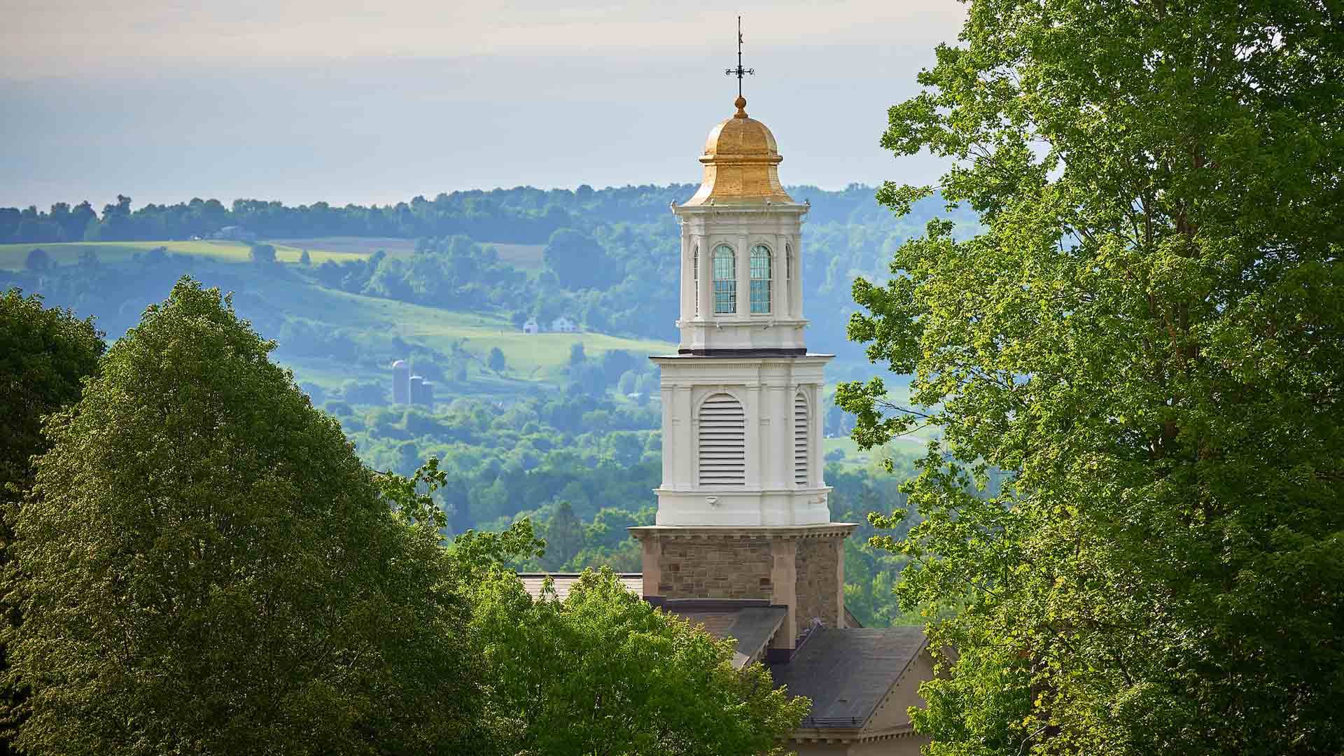 Colgate University Memorial Chapel rises above the trees.