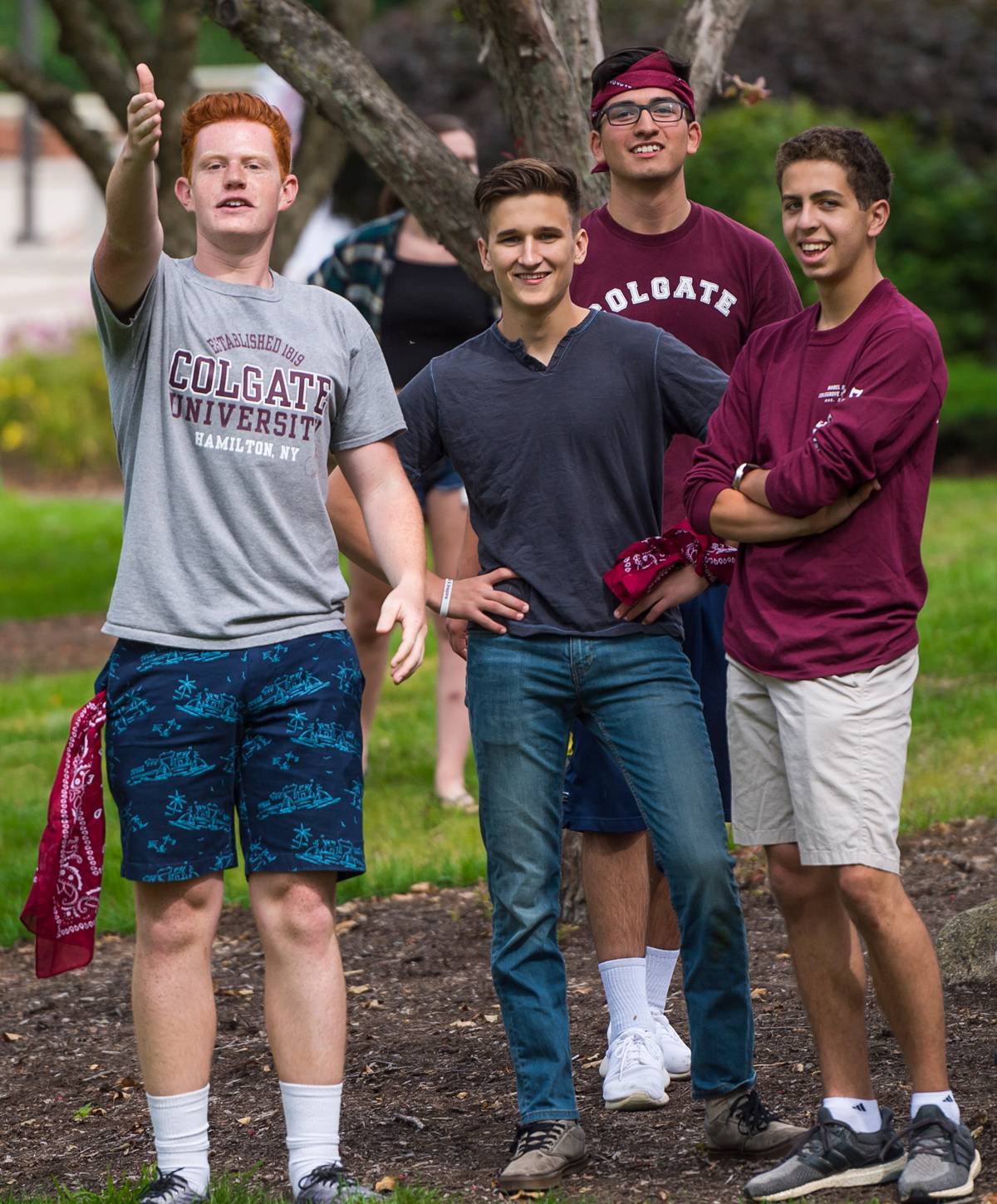 Four men playing cornhole on campus