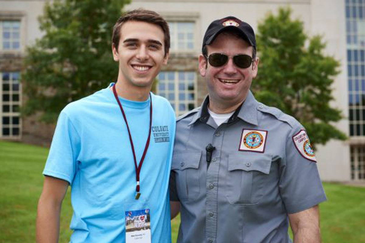 Student stands with member of Campus Safety.