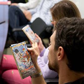 People look at books that are in their hands.