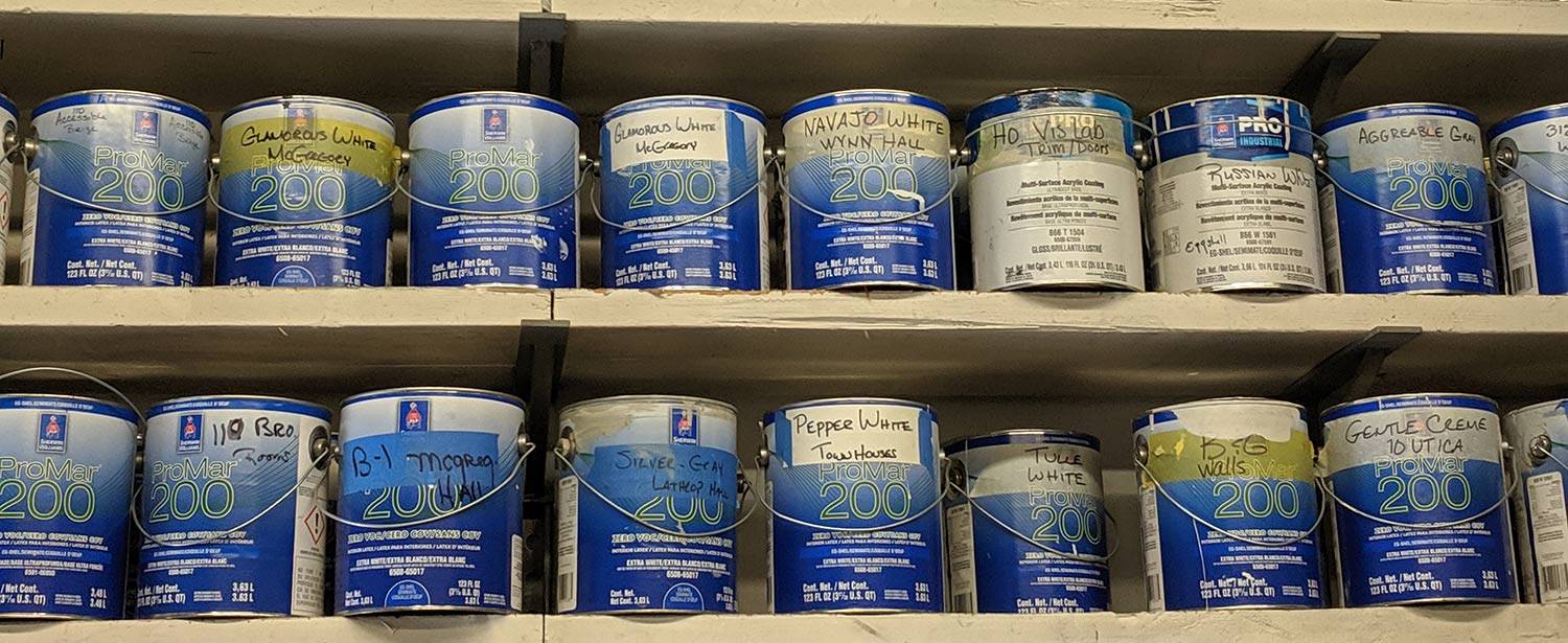 Shelves of paint cans in the Colgate paint shop