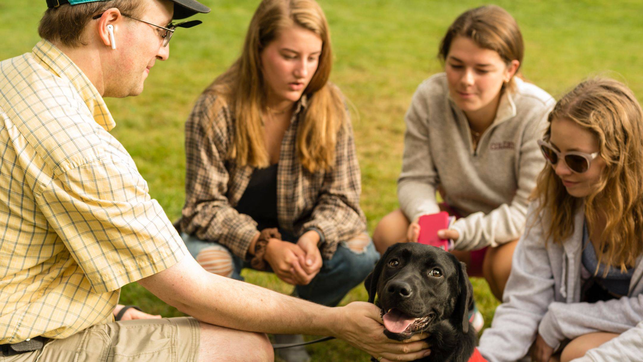 Students pet a Labrador