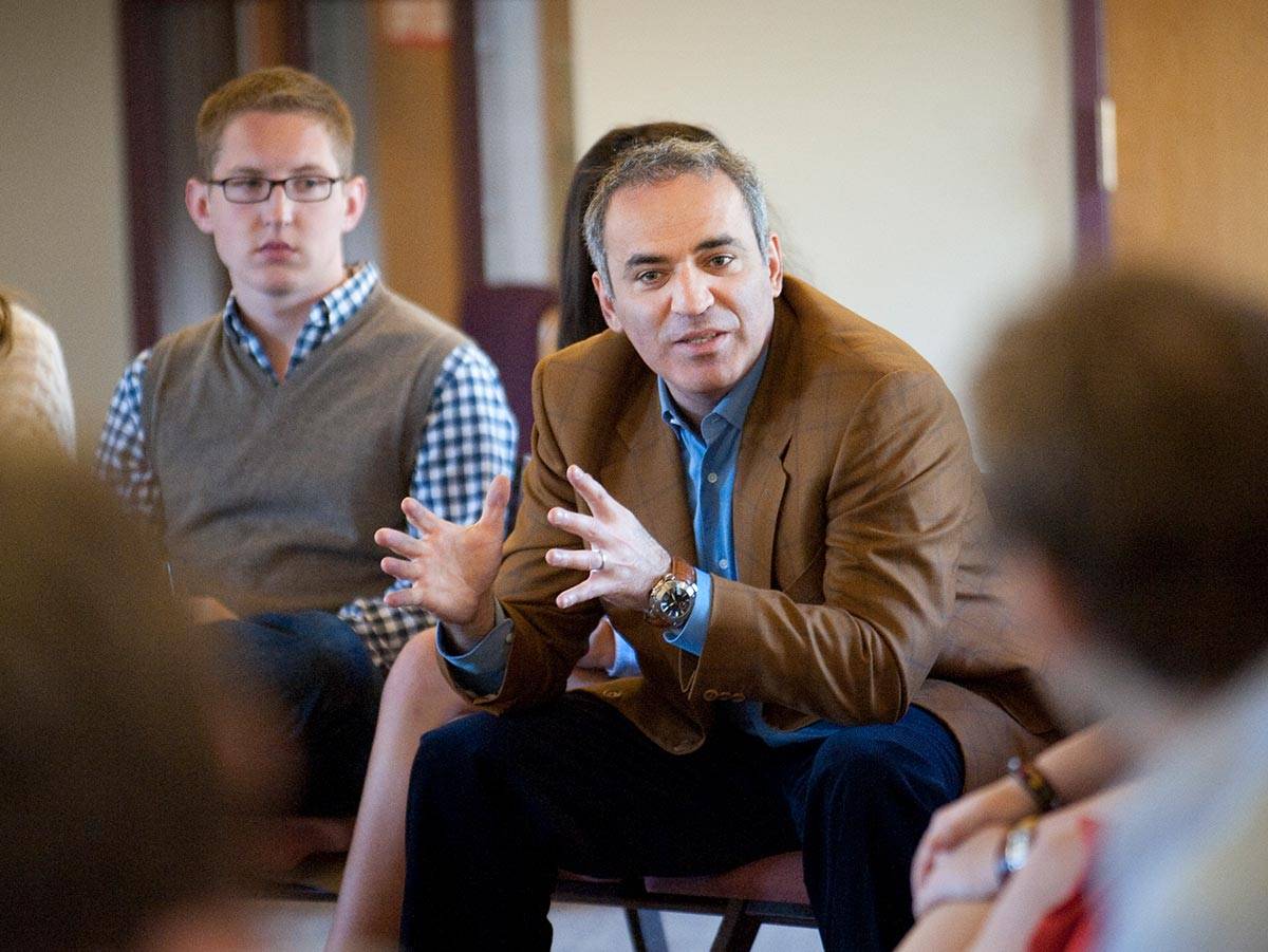 Garry Kasparov has a discussion while seated with a class of students