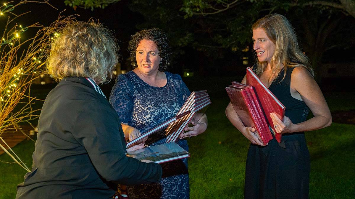 University Events Staff hand out books at an event