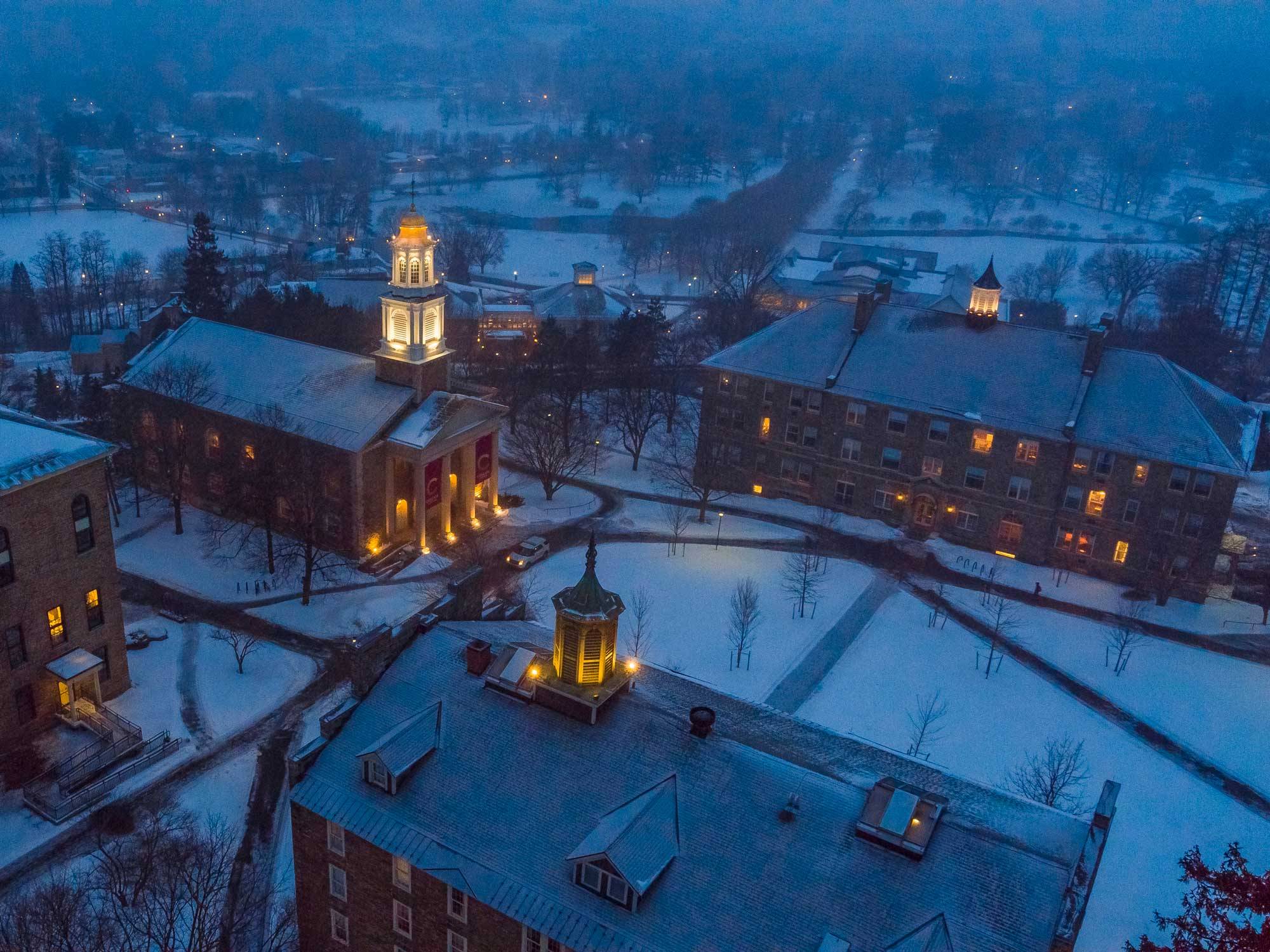 Campus buildings at dusk with snow on ground