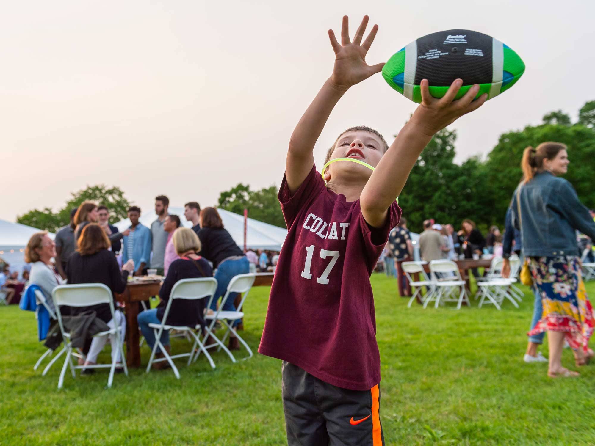 Child catches ball during Reunion picnic