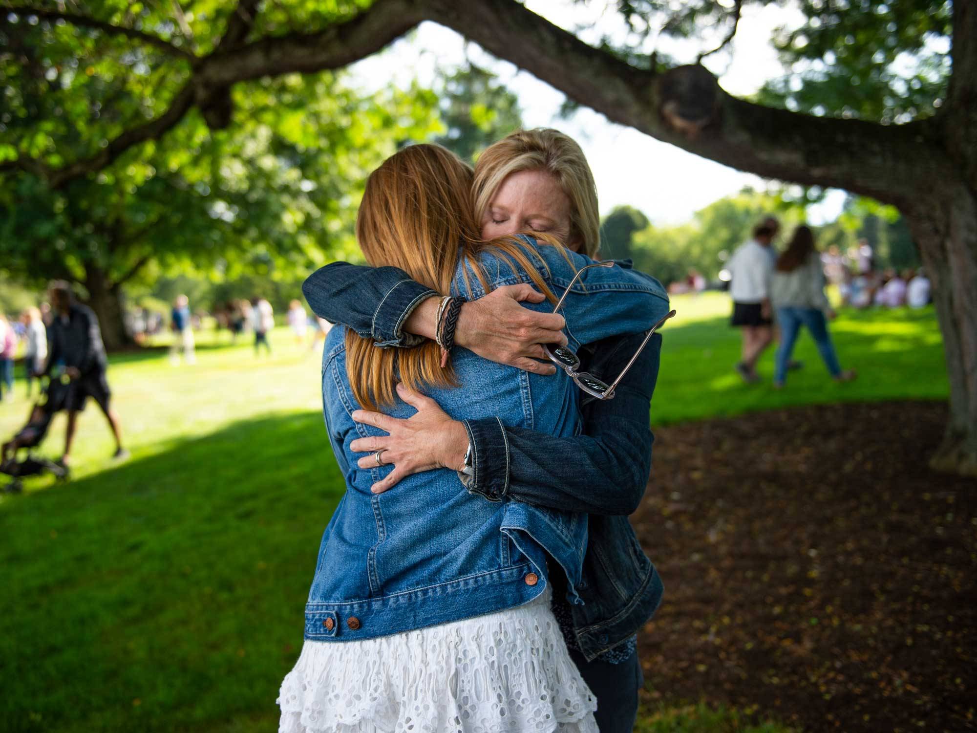 mother and daughter hug during arrival day