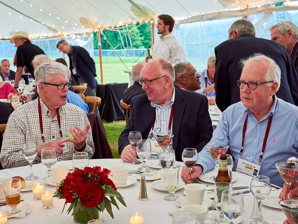 Alumni chat over a meal