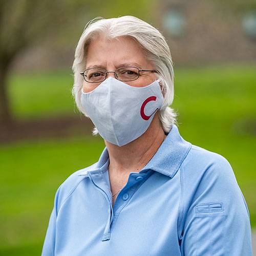 A Colgate employee models a Colgate face covering