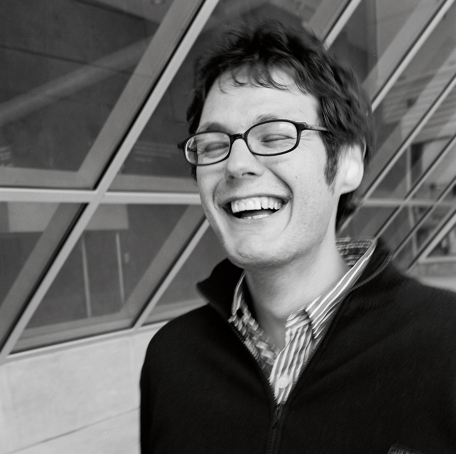 B&W photo of Ilya Kaminsky smiling