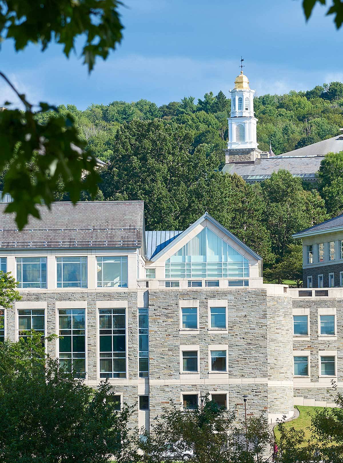 Memorial Chapel visible over Case library in a green summer scenic